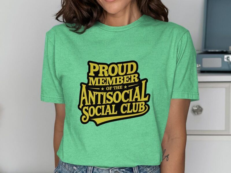Woman wearing a green t-shirt with "PROUD MEMBER OF THE ANTISOCIAL SOCIAL CLUB" printed in bold black and yellow text.