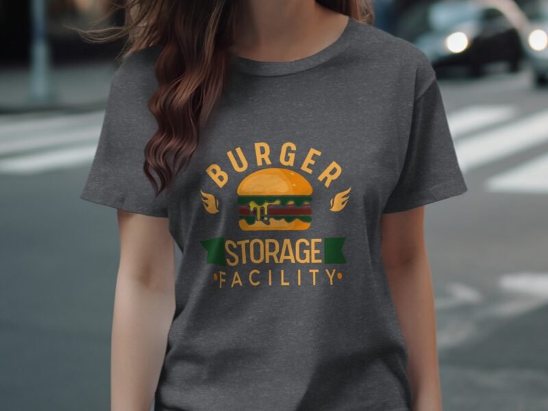 A woman in a gray t-shirt featuring a burger graphic and the words "BURGER STORAGE FACILITY" in colorful text.