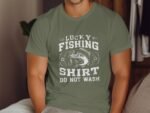 A person wearing an olive green t-shirt with "Lucky Fishing Shirt Do Not Wash" graphic design.