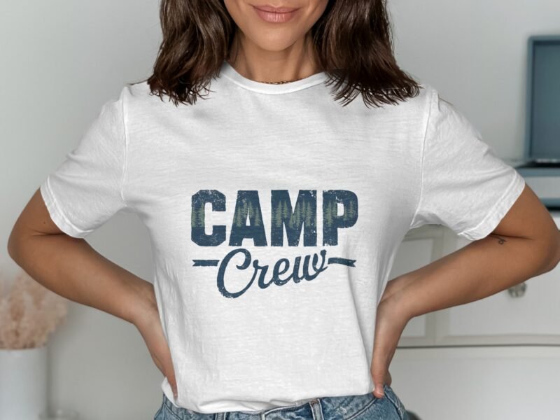 A woman poses with hands on hips wearing a white t-shirt with the text "CAMP Crew" printed in blue.