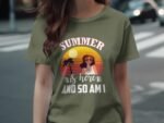 A woman wearing an olive green t-shirt with "SUMMER is here AND SO AM I" and a graphic of a woman in sunglasses.