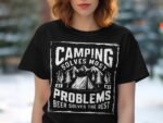 Woman wearing a black t-shirt with a camping-themed graphic that reads "Camping solves most problems, beer solves the rest."