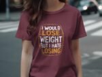 A woman in a maroon t-shirt with the text "I would lose weight but I hate losing" walks on a city street.