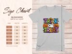A gray t-shirt displays "TRICK OR TREAT" in colorful letters with pumpkins and a ghost graphic; includes a size chart.