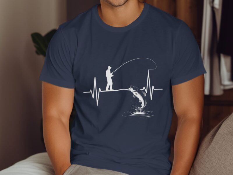 A man fishing on a heartbeat line, with a leaping fish and water splashes, depicted on a blue t-shirt.