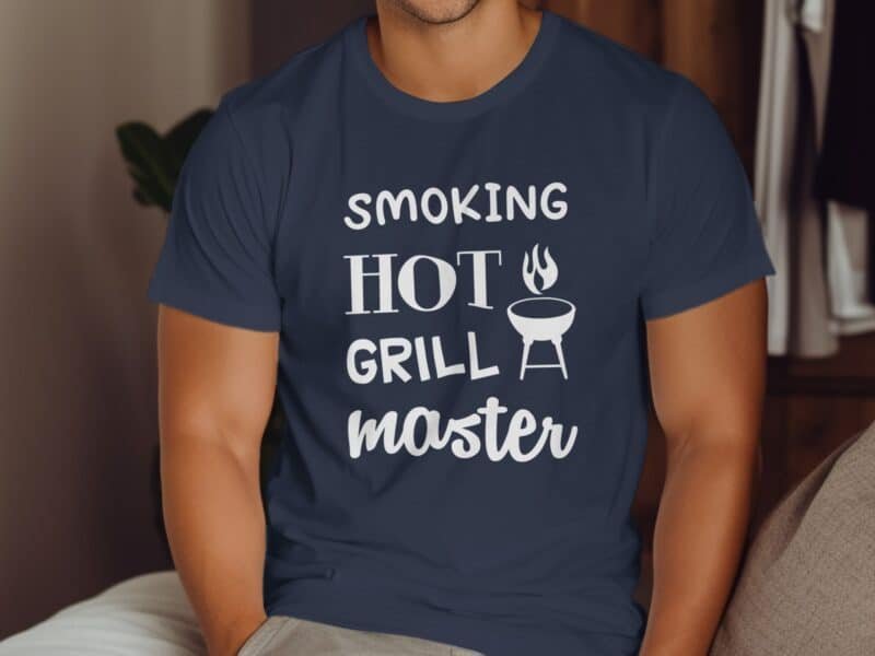A person wearing a navy blue t-shirt with the words "Smoking Hot Grill Master" and a graphic of a grill.