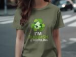 A person wearing an olive green t-shirt with a recycling logo and the text "I'M RUBBISH AT RECYCLING."