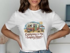 A woman in a white t-shirt featuring a colorful camping graphic with text "Camping is my happy place."