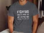 A person wearing a dark gray t-shirt with the text "Fishing solves most of my problems. Hunting solves the rest."