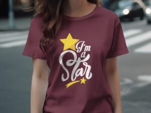 A woman wearing a maroon t-shirt with the text "I'm a Star" and a yellow star graphic, standing on a street.