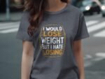 A woman wearing a gray t-shirt with a humorous quote about weight loss.