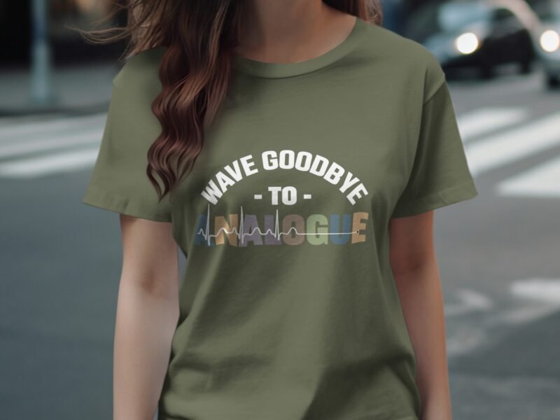 A person wearing an olive green t-shirt with the text "WAVE GOODBYE TO ANALOGUE" in stylized colors.