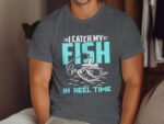 A man in a gray t-shirt features a graphic that says "I catch my FISH IN REEL TIME," with a fishing scene illustration.
