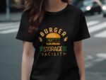 Black t-shirt featuring a colorful burger graphic with the text "BURGER STORAGE FACILITY" and wings design.