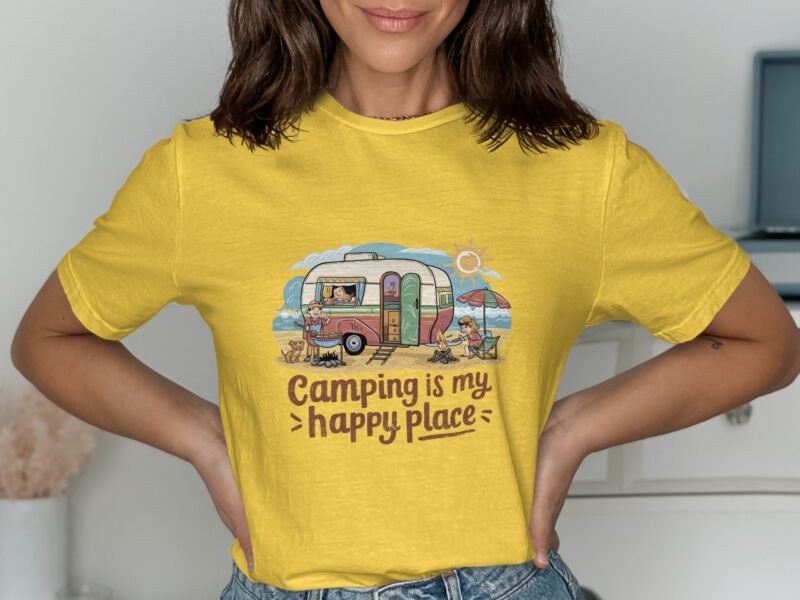 Woman wearing a yellow shirt with a camping-themed illustration and the text "Camping is my happy place."