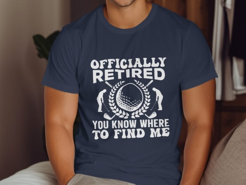 A person wearing a navy blue t-shirt with "Officially Retired" and golf-themed graphics.