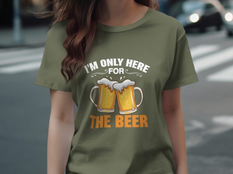 A person wearing an olive green t-shirt with the text "I'm only here for THE BEER" and two beer mugs graphic.