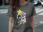 A woman wears a gray t-shirt with the text "I'm a Star," featuring a yellow star and decorative elements.