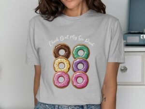 Woman wearing a gray t-shirt with a colorful donut graphic and text saying "Check Out My Six Pack."