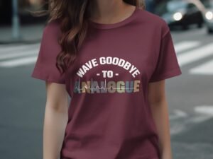 A person wearing a maroon t-shirt with the text "WAVE GOODBYE TO ANALOGUE" in bold, colorful lettering.