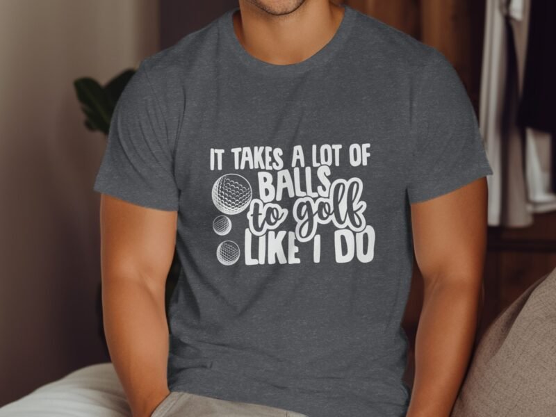 Man wearing a dark gray t-shirt with the text "It takes a lot of balls to golf like I do" and two golf ball illustrations.