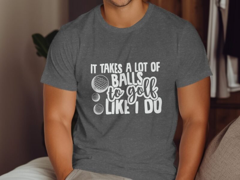 Man wearing a gray t-shirt with the text "It takes a lot of balls to golf like I do" and golf ball graphics.