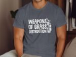 A man wearing a dark gray t-shirt with "WEAPONS OF GRASS DESTRUCTION" printed in white, next to a golf bag graphic.