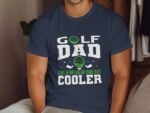 A man wearing a navy blue t-shirt with a humorous "Golf Dad" design, featuring golf balls and clubs.