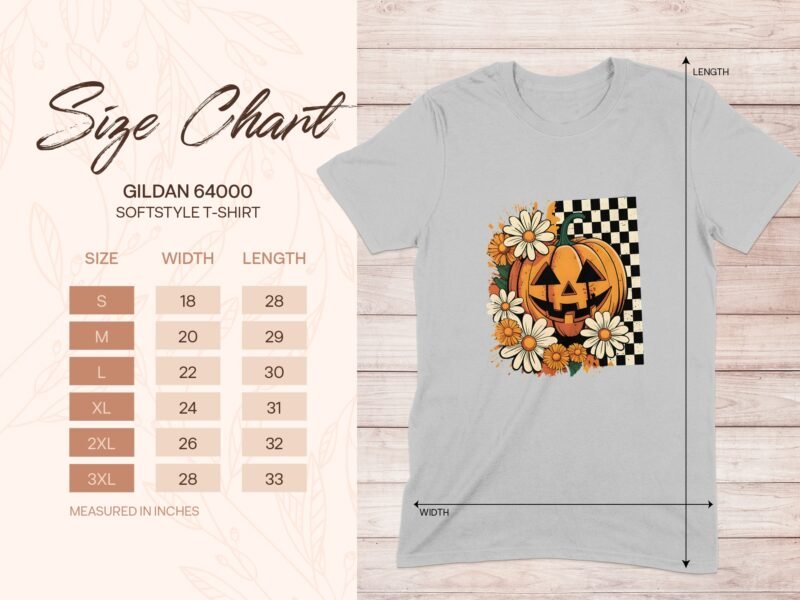 Size chart for Gildan 64000 softstyle T-shirt with floral and pumpkin graphic on a light grey fabric background.