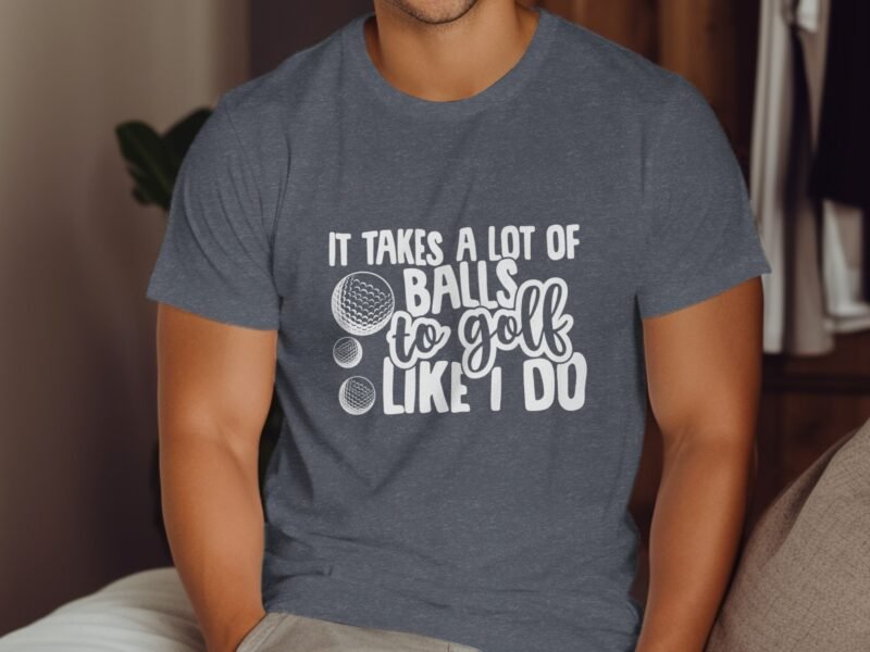 A man wearing a gray t-shirt with the text "It takes a lot of balls to golf like I do" and golf ball illustrations.