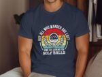 Man wearing a navy t-shirt with a humorous golf-themed graphic and text about wandering and searching for golf balls.