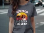 A woman in a gray t-shirt that says "SUMMER is here AND SO AM I," featuring a sunset and palm trees illustration.