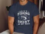 Person wearing a navy t-shirt with the text "Lucky Fishing Shirt Do Not Wash" and an illustration of a fish.
