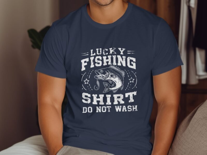 Person wearing a navy t-shirt with the text "Lucky Fishing Shirt Do Not Wash" and an illustration of a fish.