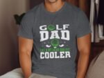 A man wearing a gray t-shirt with the text "GOLF DAD like a regular dad but cooler," featuring golf graphics.