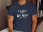 A man in a navy t-shirt with the text "I LOVE IT WHEN MY WIFE LETS ME GO FISHING" displayed prominently.
