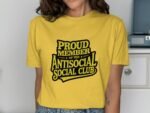 A person wearing a yellow t-shirt with the text "PROUD MEMBER OF THE ANTISOCIAL SOCIAL CLUB" printed in black.