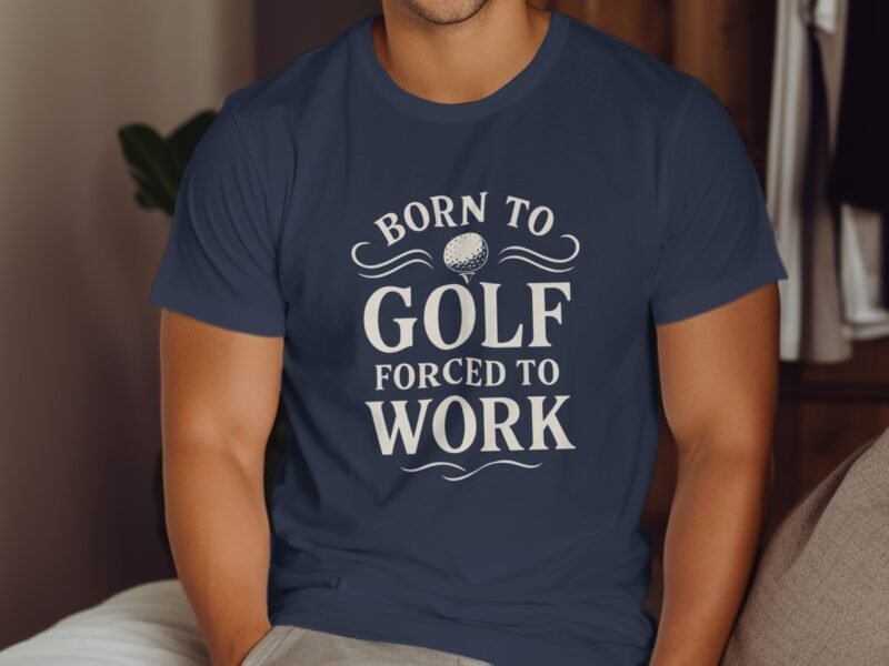 A man wearing a navy shirt with the text "Born to Golf Forced to Work" and a golf ball graphic.