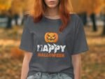 Woman wearing a gray t-shirt with "Happy Halloween" text and a jack-o'-lantern design, surrounded by autumn scenery.