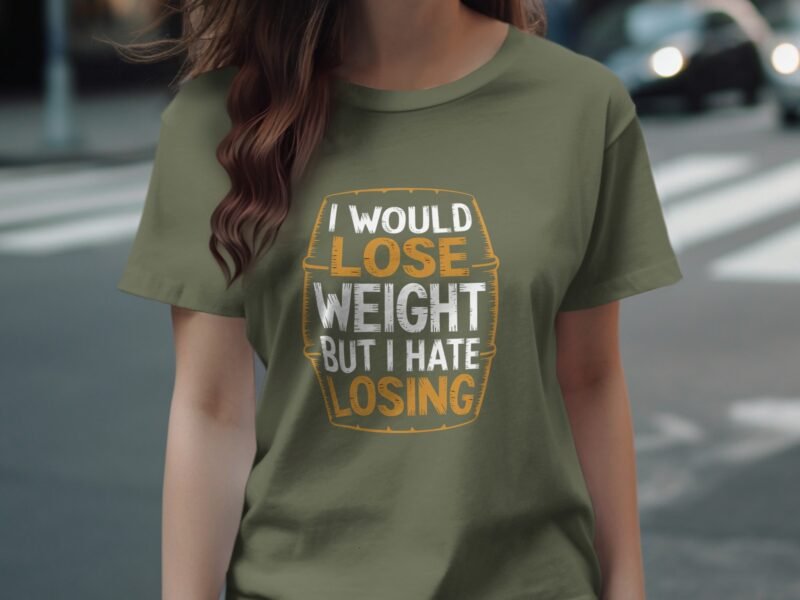 Woman wearing an olive green t-shirt with a humorous slogan about losing weight and hating losing.