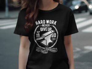Black t-shirt with white text featuring an anvil and the phrases "Hard Work Never Give Up" and "Quality Premium Iron."