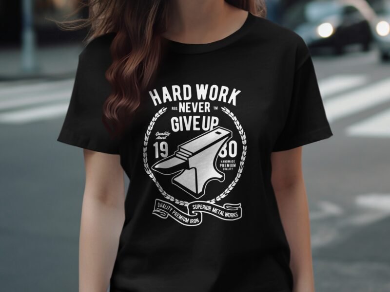 Black t-shirt with white text featuring an anvil and the phrases "Hard Work Never Give Up" and "Quality Premium Iron."