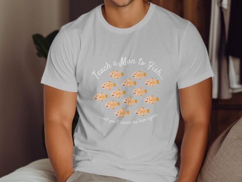 A man wearing a white t-shirt with a humorous "Teach a Man to Fish" graphic featuring cartoon fish.