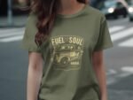 Woman wearing an olive green t-shirt with a vintage truck graphic and the text "Fuel for the Soul, Garage Built."