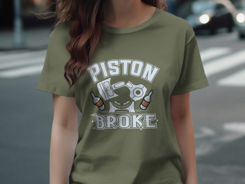 A woman wears an olive green t-shirt with the text "PISTON BROKE" and graphic images of beer bottles and pistons.
