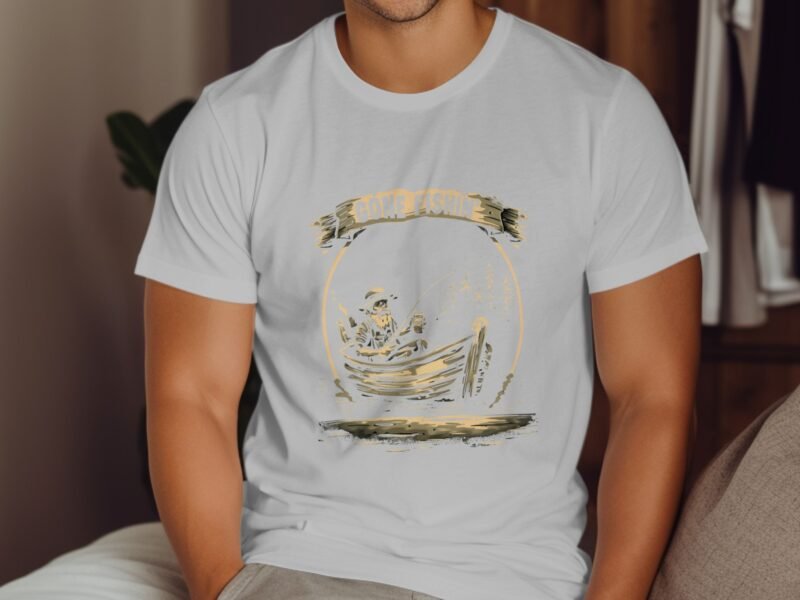A man wearing a white t-shirt with a fishing graphic sits against a wooden backdrop, showcasing a casual look.
