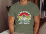 A man in a green t-shirt featuring a golf ball graphic and the text about wandering and looking for golf balls.