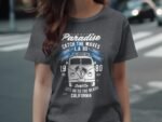 A woman in a gray t-shirt featuring a vintage van graphic with "Summer Paradise" and "Catch the Waves" text.
