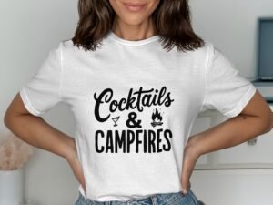A woman in a white t-shirt with "Cocktails & Campfires" printed in black, smiling and posing against a light background.