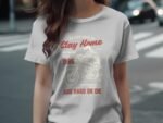 A woman wears a light gray t-shirt featuring motorcycle-themed graphics and text promoting bike culture.